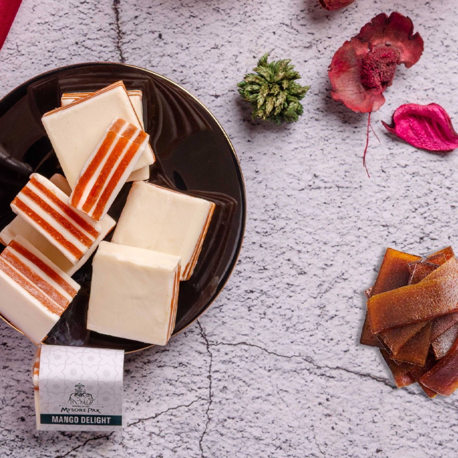 Buy Aam Papad Sweet online from World of Mysore Pak — tangy mango paired with soft white chocolate and pure ghee.
