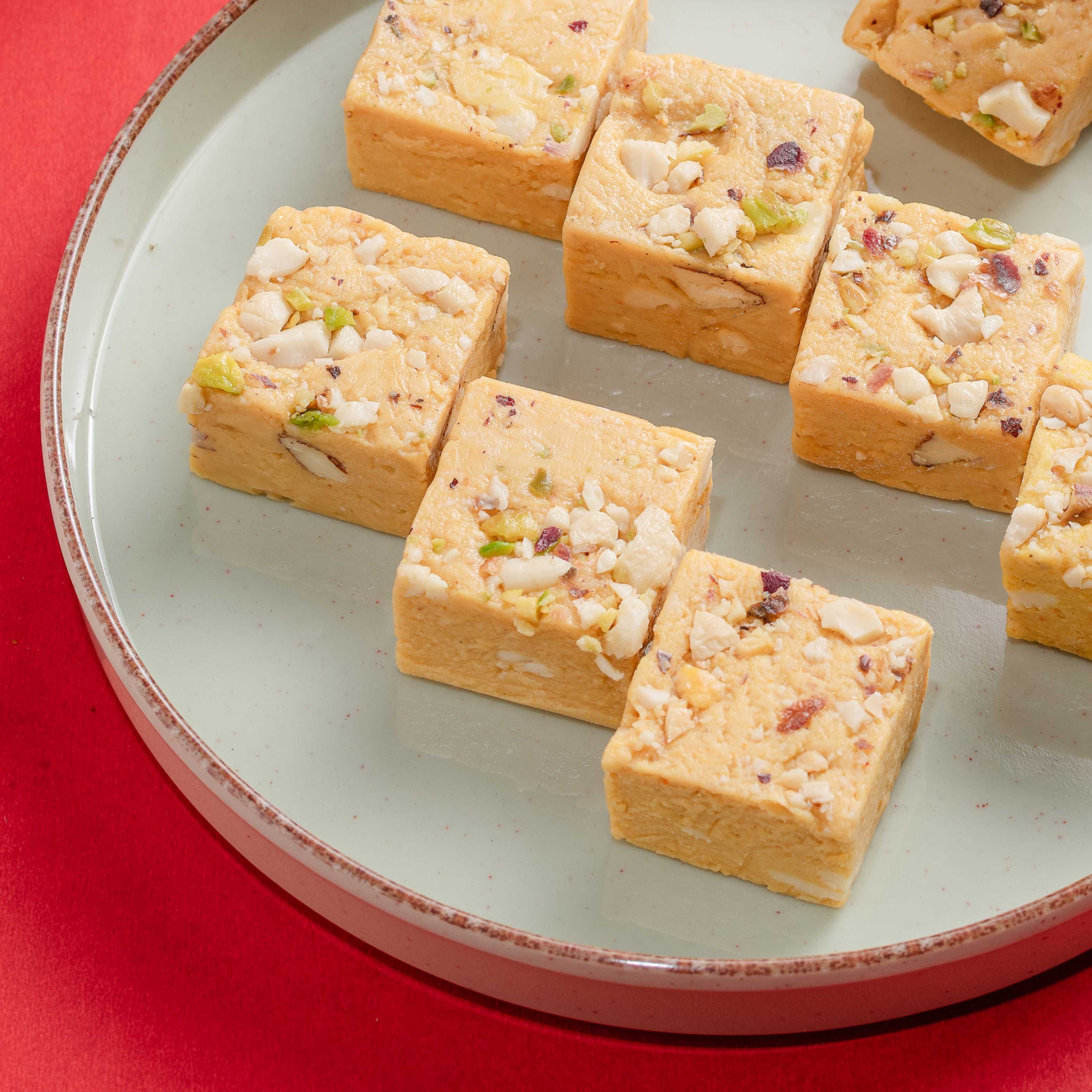 Buy smooth, flavorful saffron Kesar Bites online from World of Mysore Pak — made with kaju, ghee, and kesar.
