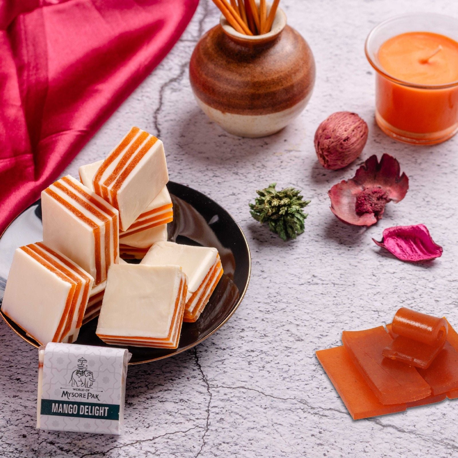 Buy Mango Delight Sweet online from World of Mysore Pak — a fruity blend with ghee and white chocolate layers.