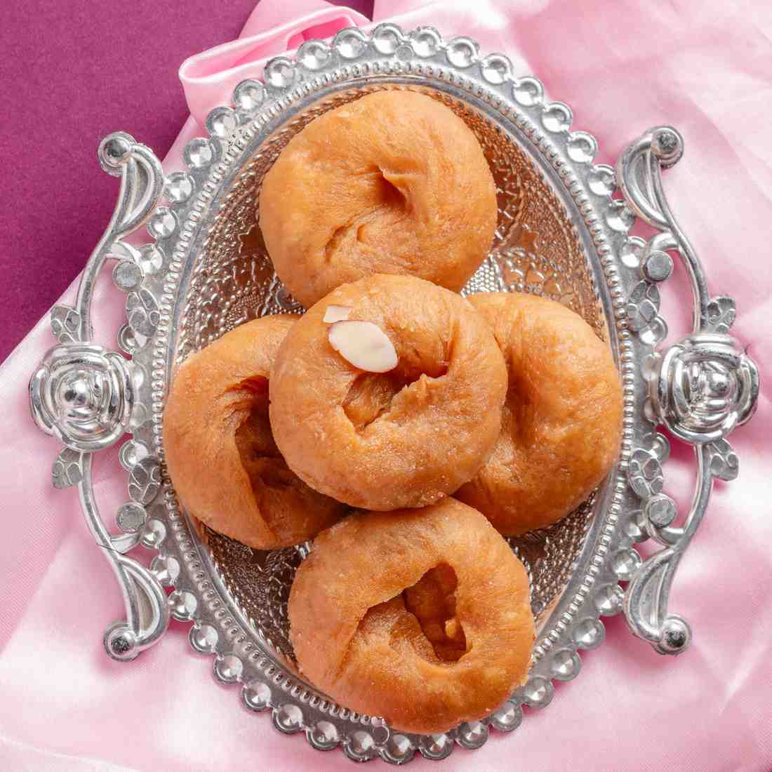 Buy sweet Badusha, made with pure ghee, online at World of Mysore Pak. Savor the delicious Balushahi treat.