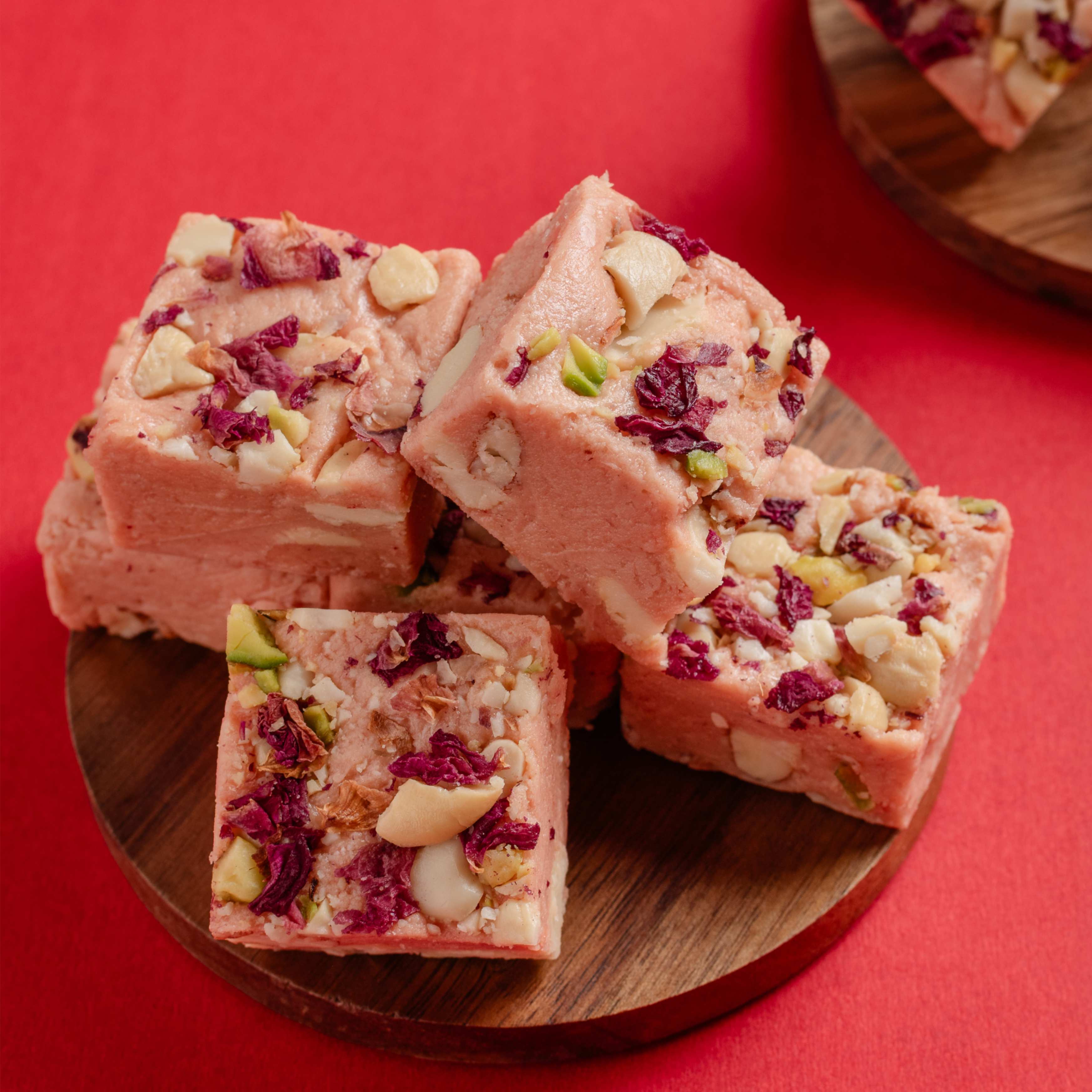 Buy Rose Bites online from World of Mysore Pak. Made with kaju paste, 100% pure ghee & rose petals. 